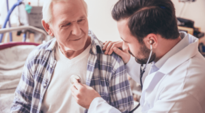 Doctor holds stethoscope to mesothelioma patient's chest