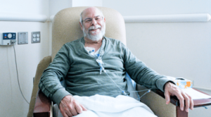 Man smiles while receiving chemotherapy