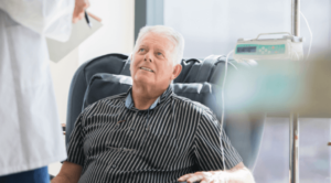 Patient receives chemotherapy and talks with doctor