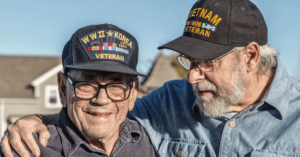 Two veterans standing together smiling